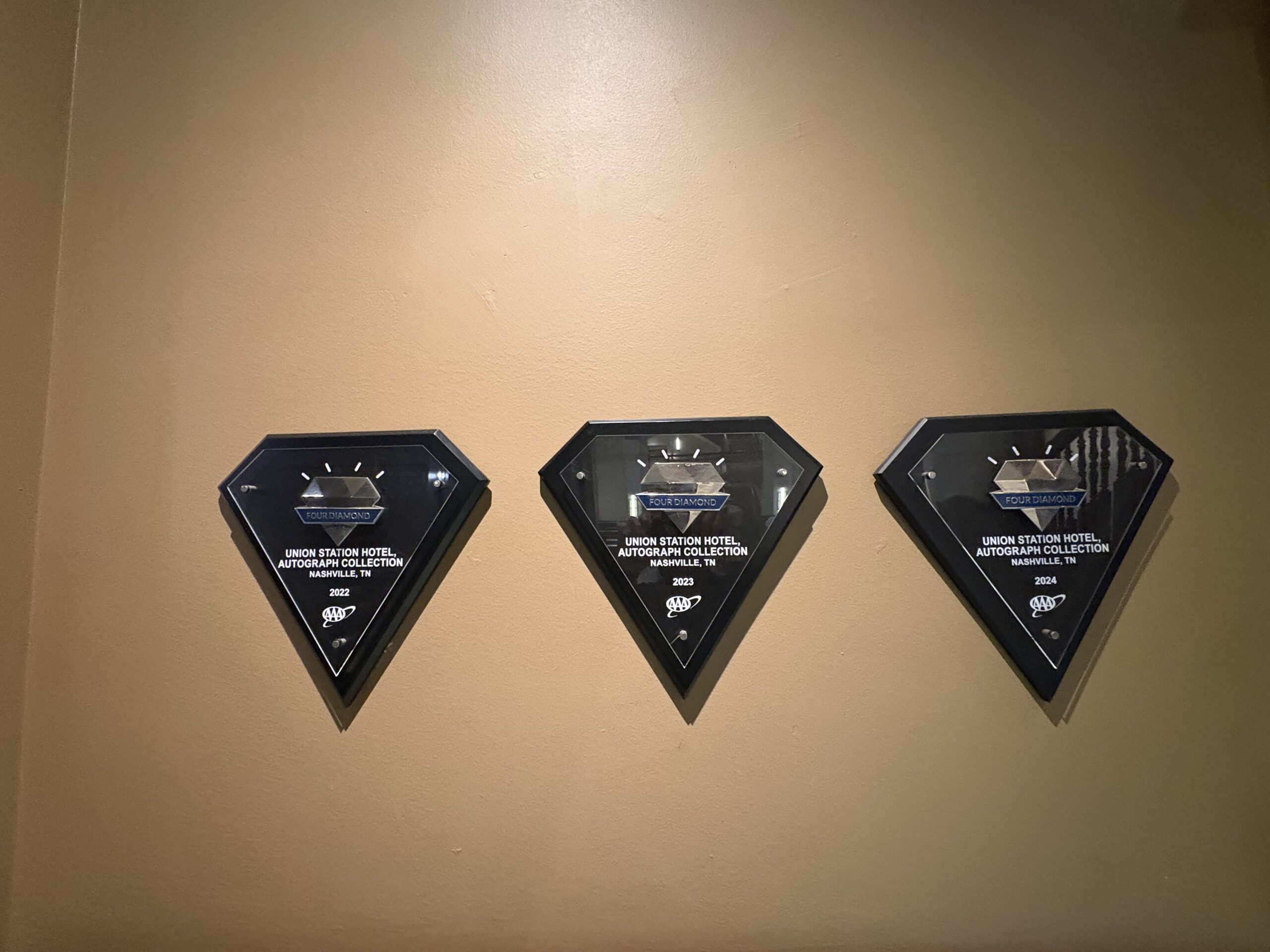 Three AAA Four Diamond award plaques for Union Station Hotel Nashville from 2022, 2023, and 2024
