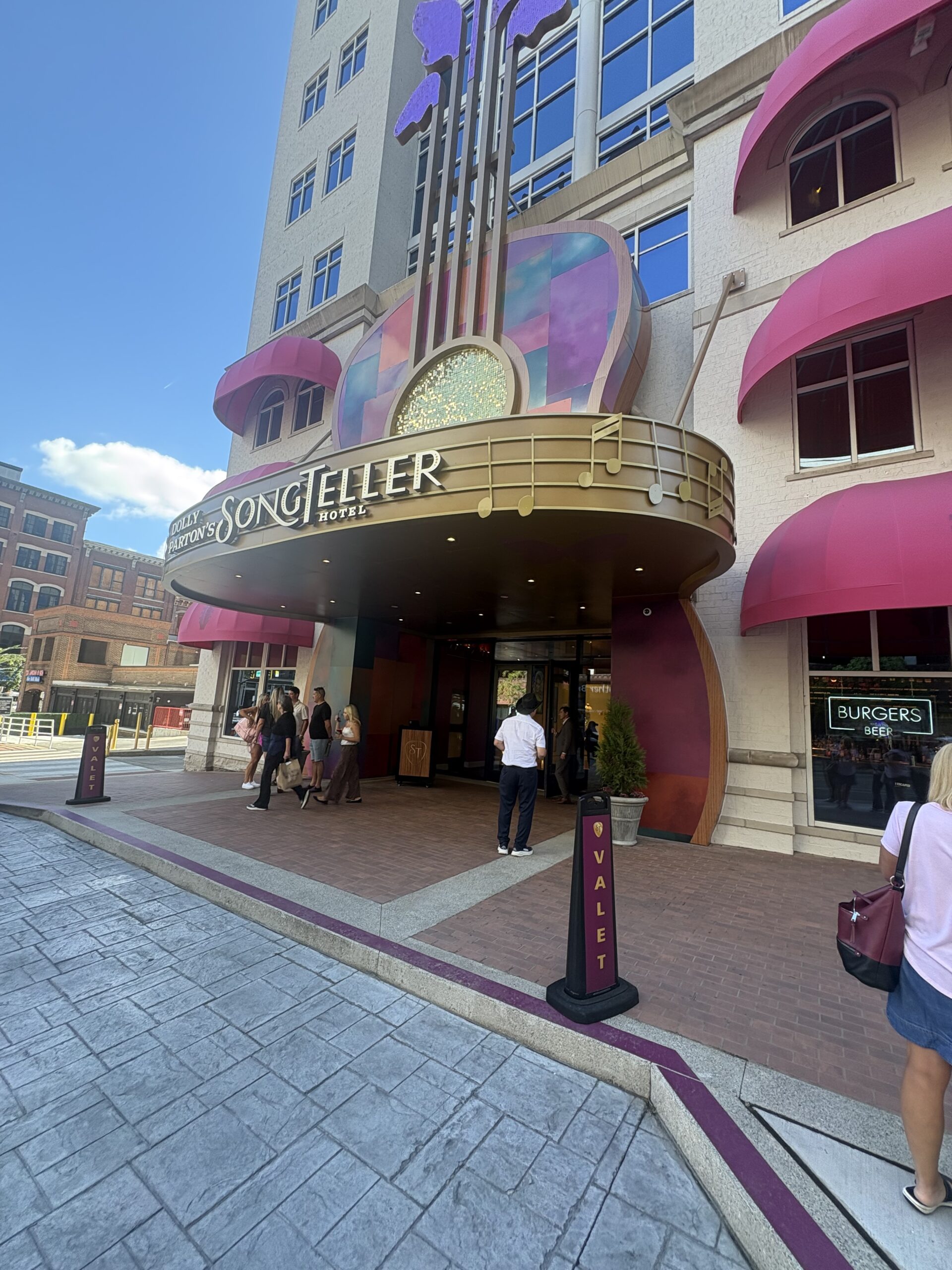 Visitors gathered under the SongTeller Hotel marquee with valet signs out front in Nashville