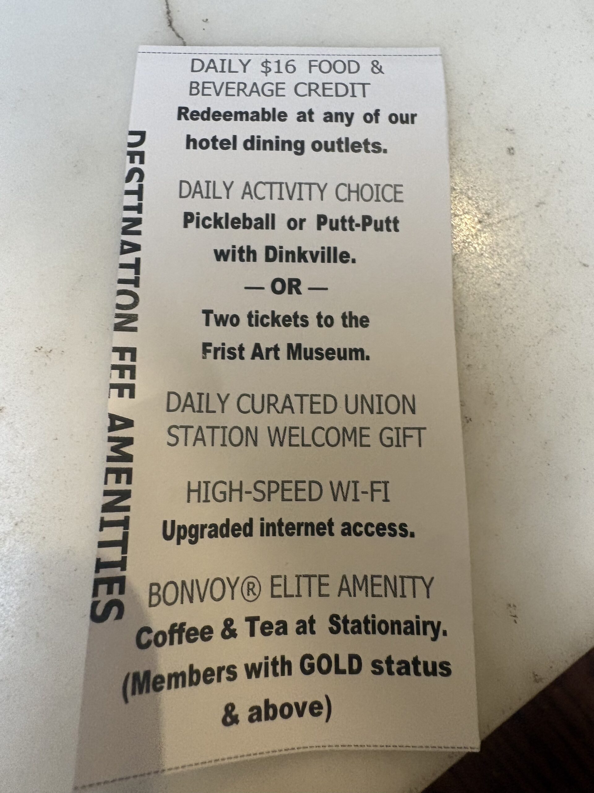 Union Station Nashville destination fee amenities card listing a daily $16 food and beverage credit, pickleball or Frist Art Museum tickets, and Wi-Fi